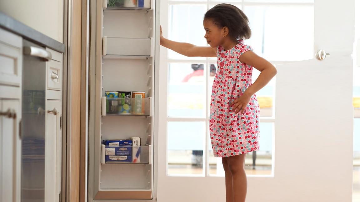 girl looking in kitchen pantry