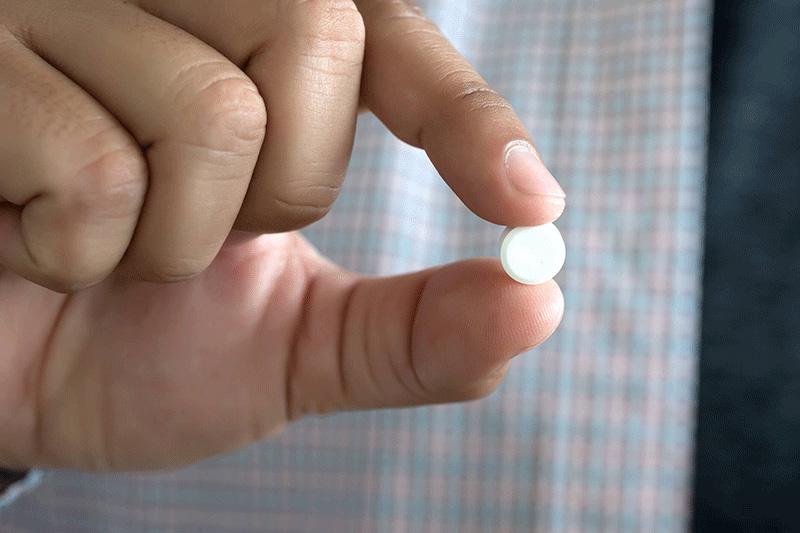 pill in fingertips